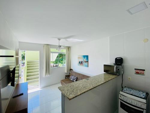 a kitchen with a counter top and a stove at Edifício Flora in Angra dos Reis