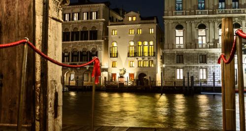 a view of a river with buildings in the background at Hotel Palazzina Grassi in Venice