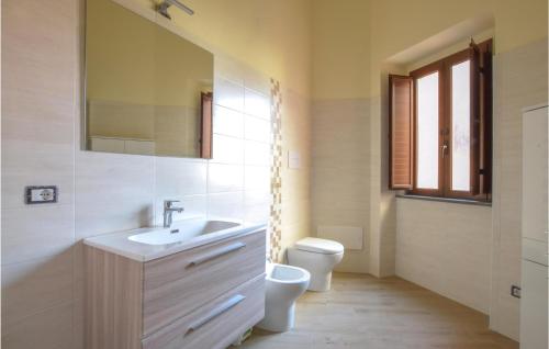 La salle de bains est pourvue d'un lavabo, de toilettes et d'un miroir. dans l'établissement 2 Bedroom Stunning Apartment In Cuglieri, à Cuglieri