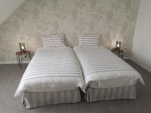 מיטה או מיטות בחדר ב-Cottage AU TERMINUS 3 climatisé