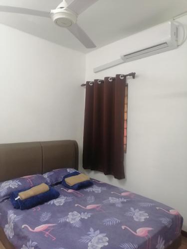 ein Schlafzimmer mit einem Bett in einem Zimmer mit einem Fenster in der Unterkunft Selesa Inn Homestay in Nilai
