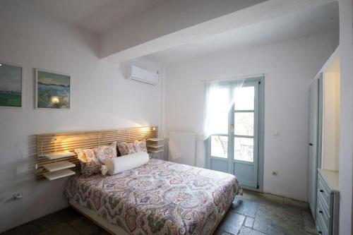 a bedroom with a bed in a white room at Villa Filitsa in Platis Gialos
