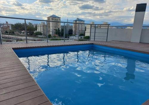 a large blue swimming pool on top of a building at TIERRA Alojamientos in Salta