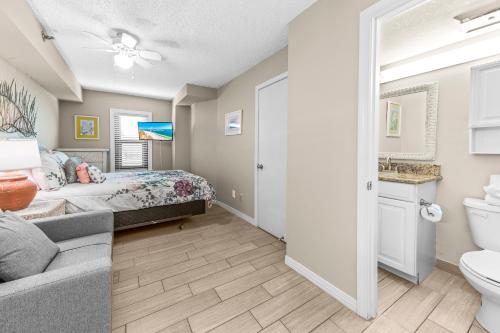 a bedroom with a bed and a bathroom with a toilet at Harbor Place 313 in Gulf Shores