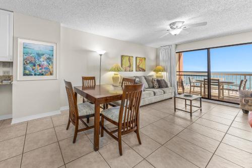 a living room with a table and chairs and a couch at Harbour Place 313 in Gulf Shores