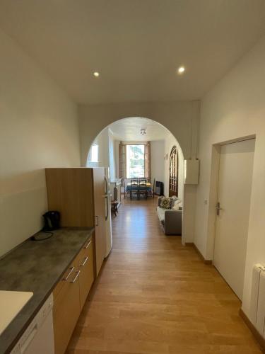 a kitchen and living room with an archway at Cassis Loc - Appartement meublé in Cassis