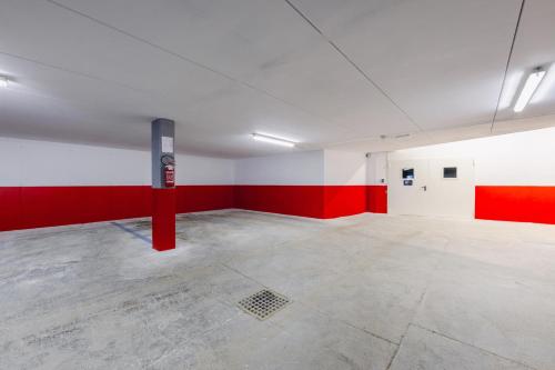 an empty room with red and white walls and a fire hydrant at Hotel Ramon in Campitello di Fassa