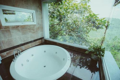 a bathroom with a white sink and a window at The Skyview Hòa Bình in Kệ Sơn