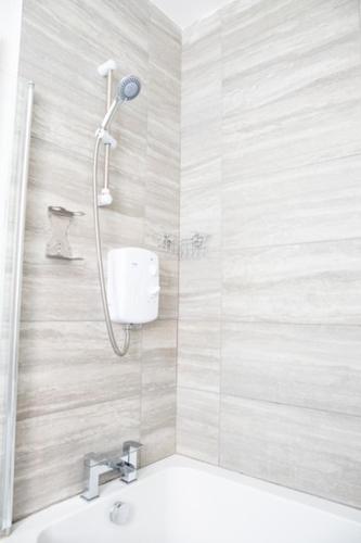 a bathroom with a shower and a sink at Withnell Stays - Apartment One - Ground Floor - Retro Gaming Machine in Blackpool