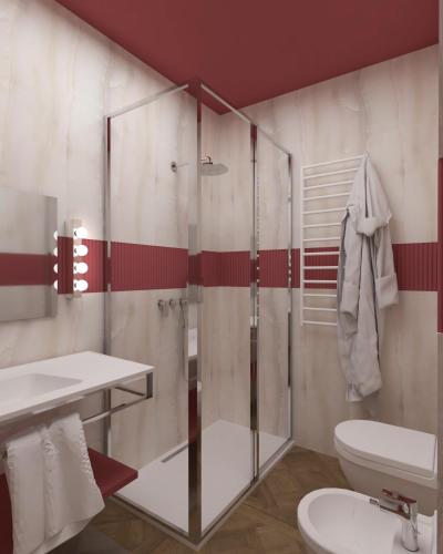a bathroom with a glass shower and a toilet at Parc Hotel Flora S in Riva del Garda
