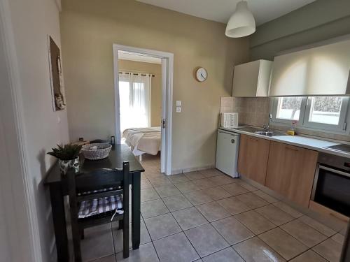 a kitchen with a sink and a table in a room at Sirios in Acharavi
