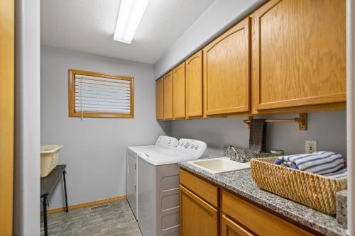a kitchen with a sink and a dishwasher at Coeur d'Alene Cozy in Coeur d'Alene