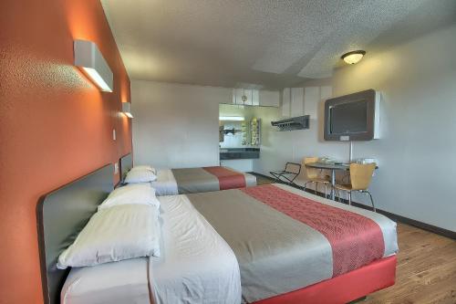 a hotel room with two beds and a television at Motel 6-Lima, OH in Lima