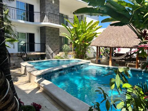 a swimming pool in front of a villa at Refugio Huasteco Hotel Boutique in Tamasopo