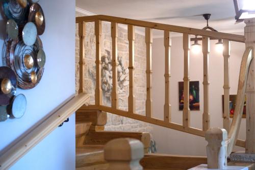 a staircase in a house with pots and pans on the wall at Family's nest in Lákka
