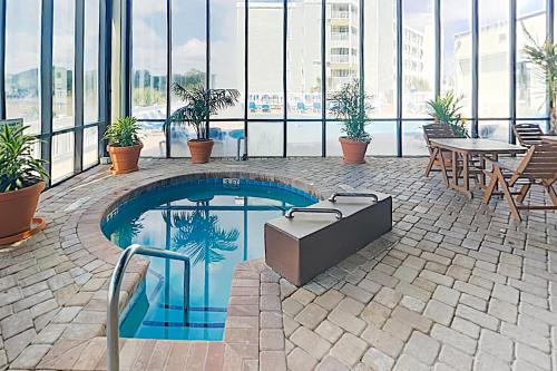a swimming pool in the middle of a building at Sands Beach Club in Myrtle Beach