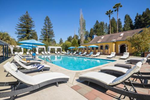 a pool with chaise lounge chairs and a resort at Surrey Resort and Gym in Guerneville