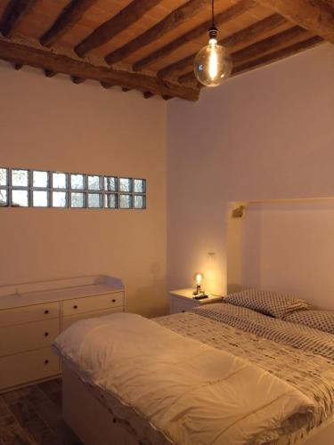 a bedroom with a bed and a dresser and a window at la stanza di Robi in Rio Marina