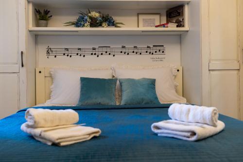 two towels on a blue bed with a sheet at Apartments Sounds of Dubrovnik in Dubrovnik