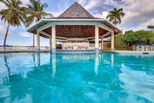 a large swimming pool with a gazebo at Starfish Tobago in Scarborough