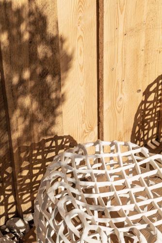 a white sculpture sitting next to a wooden wall at Hôtel Le Parc - La Table de Franck Putelat in Carcassonne