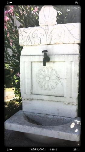 a white statue with a flower on it at Avaton Hotel in Ligourio