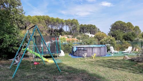 a yard with a swing set and a playground at LOUCABANON VAR in Draguignan