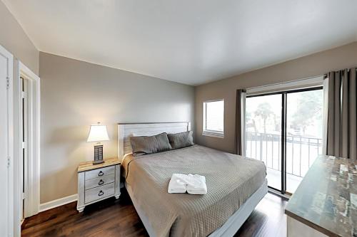 a bedroom with a bed and a large window at Palace Resort #108 in Myrtle Beach