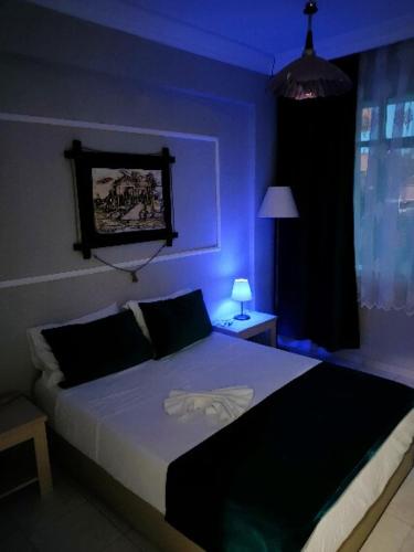 a bedroom with a bed in a blue room at Side Erenler Hotel in Side