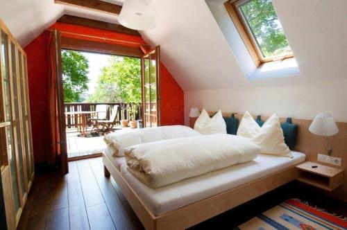 a bedroom with a large bed with a large window at Hotel Garni Winzerhof Hödl in Wagna