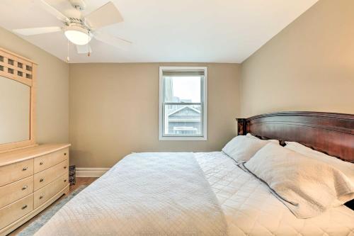 a bedroom with a bed with a ceiling fan and a window at Beautiful Spacious Beach Home, Private Deck & Grill, with Beach Badges in Point Pleasant Beach
