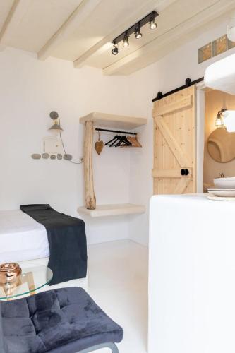 a room with a bed and a glass table at Cassaris Mykonos in Drafaki