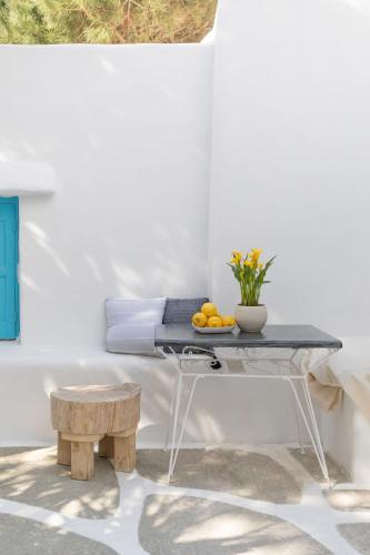 a table with a bowl of fruit on top of it at Cassaris Mykonos in Drafaki