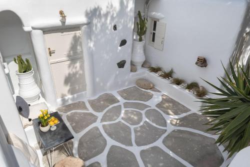 a hallway with a floor with a stone floor at Cassaris Mykonos in Drafaki