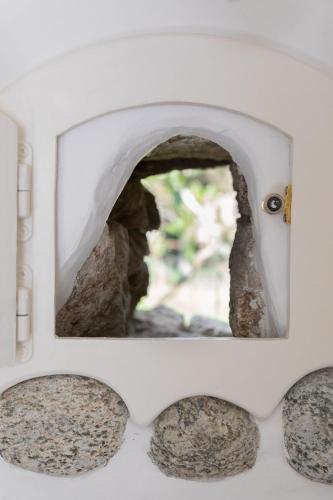 a stone oven with a window in the back at Cassaris Mykonos in Drafaki
