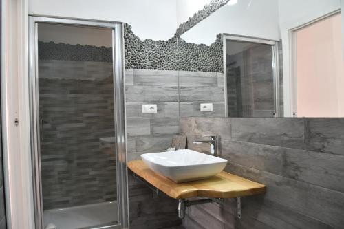 a bathroom with a sink and a shower at Angelique Affittacamere in Santa Teresa Gallura