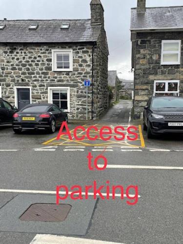 a sign that says access to parking in a parking lot at Flat 2 - Y Sgwar Restaurant in Tremadoc