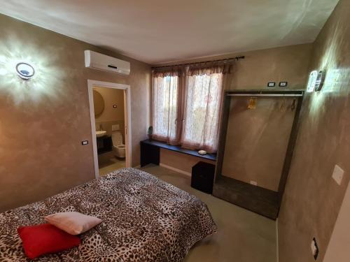 a bedroom with a leopard print bed and a bathroom at Residence Giove in Castelfranco Veneto