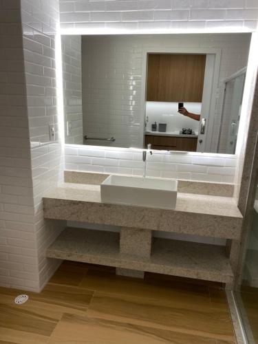a bathroom with a sink and a mirror at RESORT PRAIA DOS CARNEIROS in Tamandaré