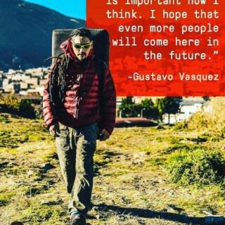 a man walking down a dirt road with a sign at Monkeywasi Climbing Hostel in Huaraz