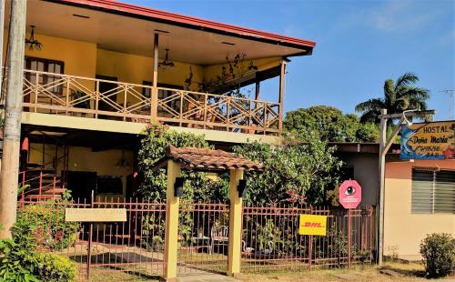 a building with a fence in front of it at Hostal Doña Maria in Pedasí Town