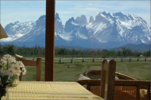 a table with a view of a snow covered mountain at Hosteria Lago del Toro in Torres del Paine