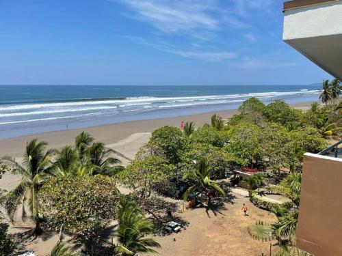 a view of the beach from the balcony of a condo at Bejuco Beachfront Condo FRENTE A LA PLAYA hermoso condominio NUEVO in Esterillos Este