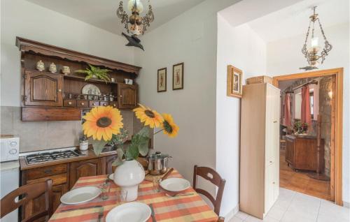 a kitchen with a table with a vase on it at Paucca 1 in San Valentino di Villa