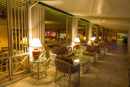 a lobby with couches and tables and lamps at Starfish Tobago in Scarborough