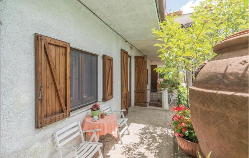 a patio with a table and chairs next to a building at Paucca 2 in San Valentino di Villa