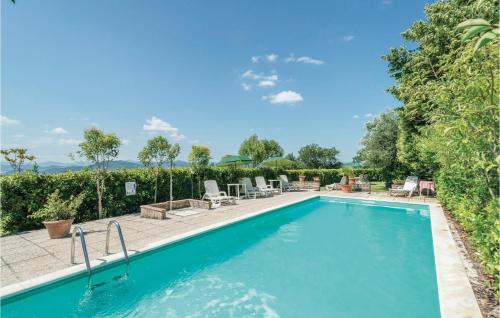 a swimming pool with chairs and a patio with at Paucca 2 in San Valentino di Villa
