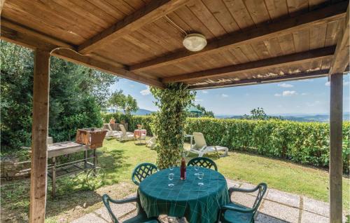 a patio with a table and chairs under a pergola at Paucca 2 in San Valentino di Villa