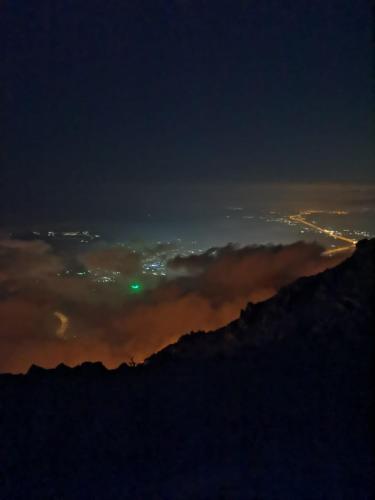 a view of the city at night from a mountain at فيلا مطل الهدا in Al Hada