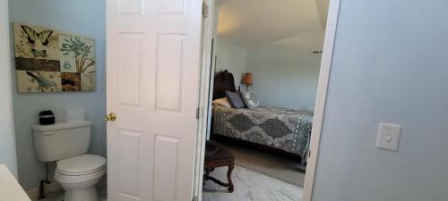 a bathroom with a toilet and a bed at Hidden Gem 2 bed 2 bath private mobile home with great parking in Fernley